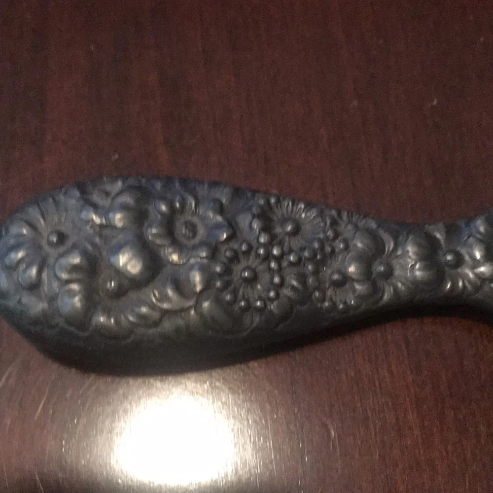 Vintage silver hand held mirror with raised flowers